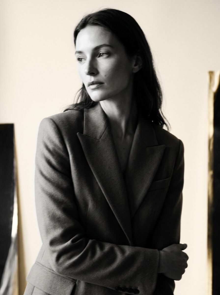 Black-and-white portrait of a model in a tailored blazer